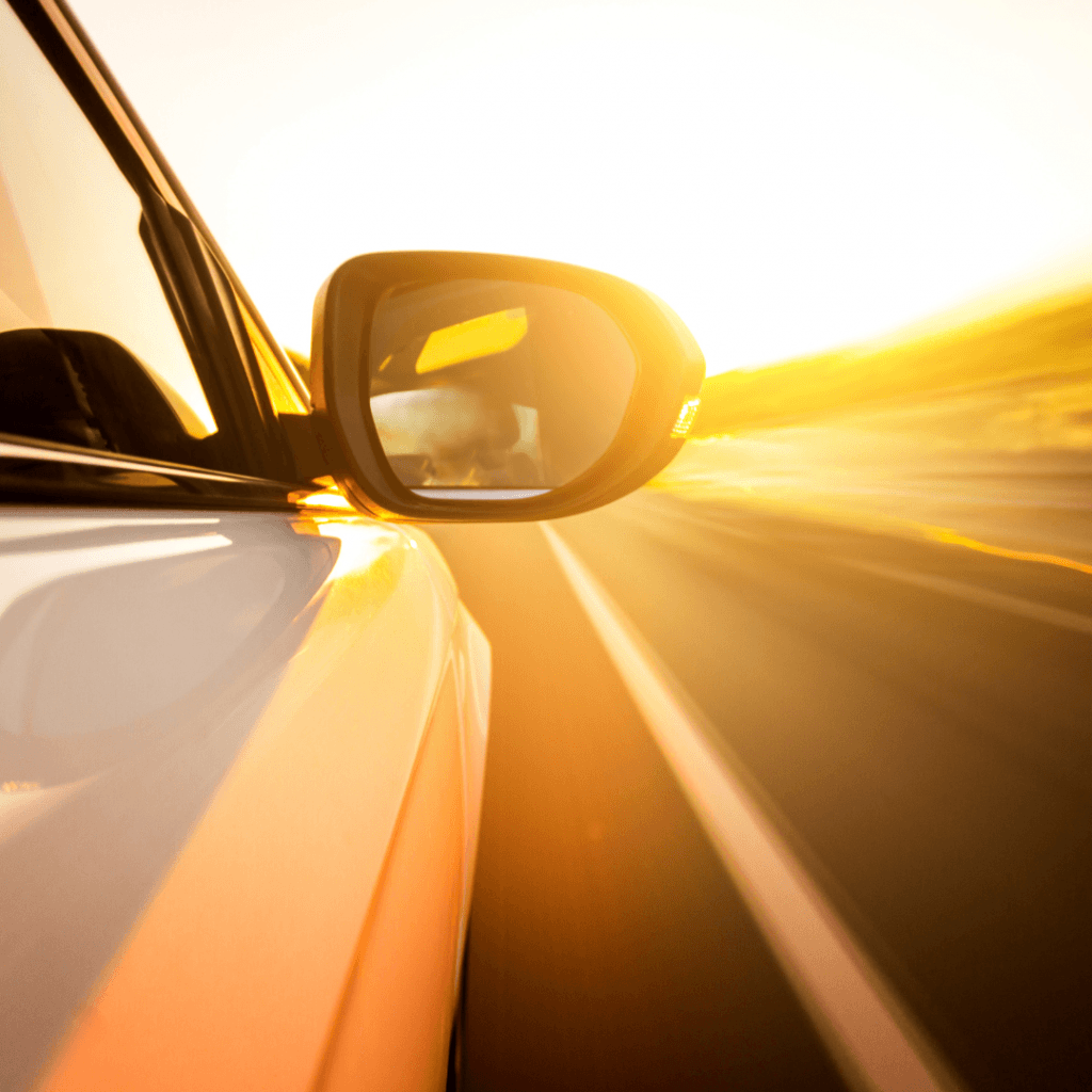 Car driving in sunshine